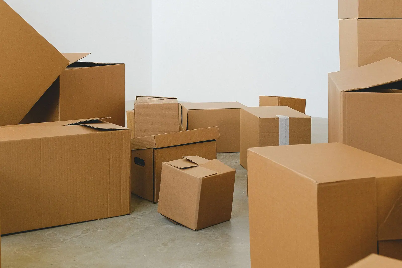 Bright room filled with open and taped moving boxes