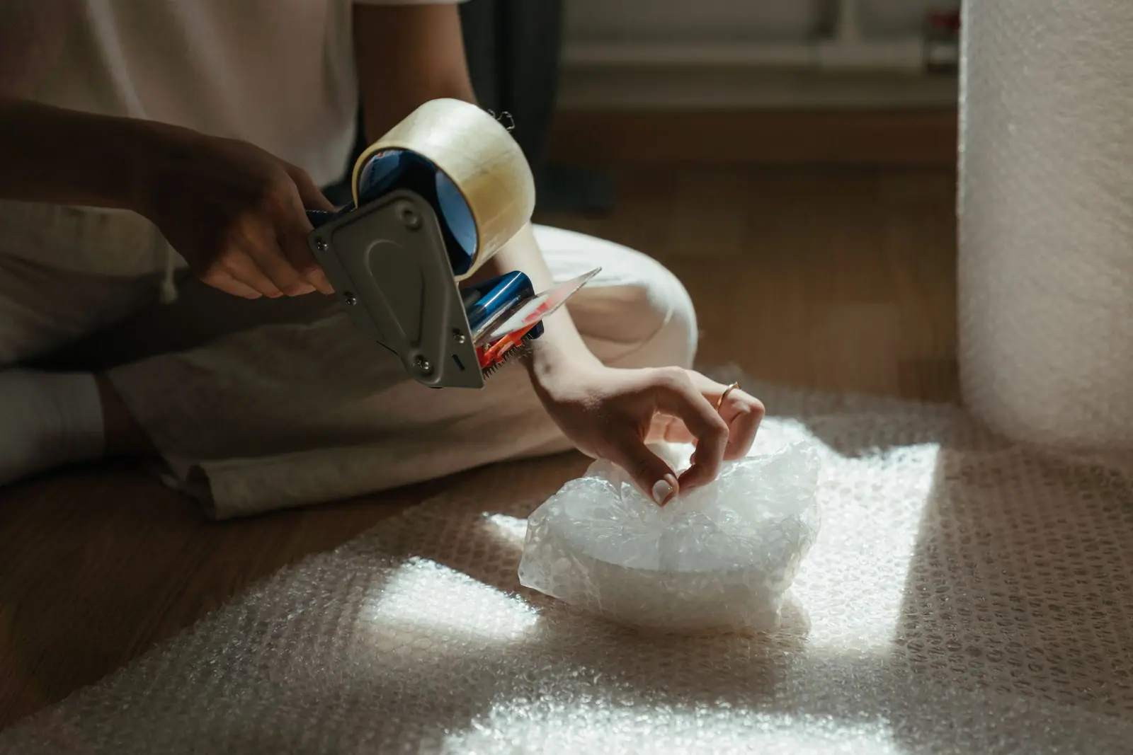 Hands taping bubble wrap