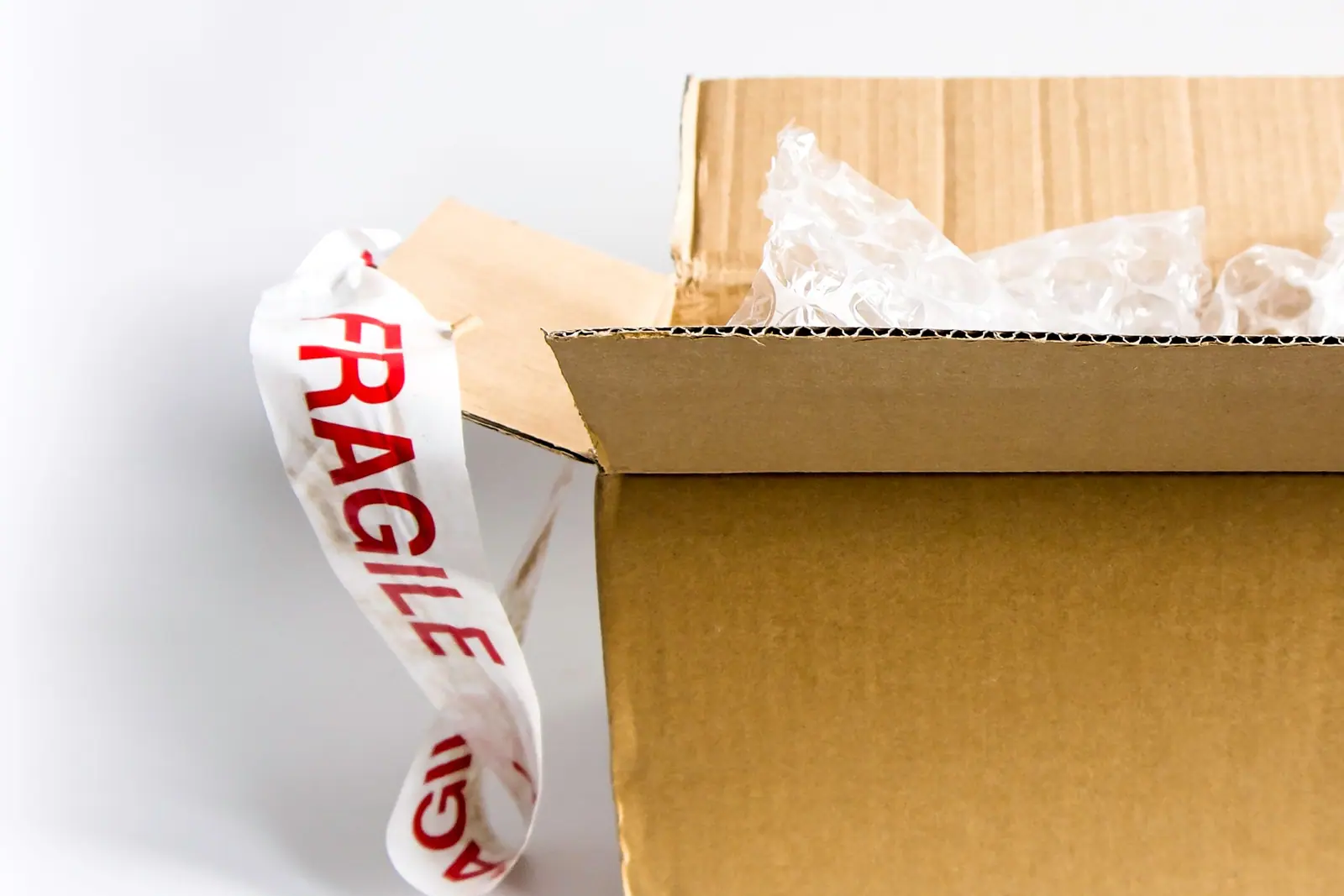 Box sealed with fragile tape and filled with bubble wrap