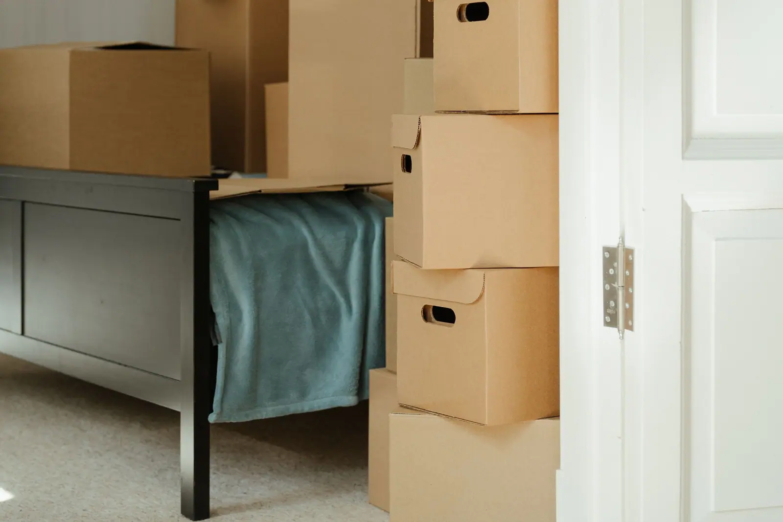 Moving boxes stacked by a front door