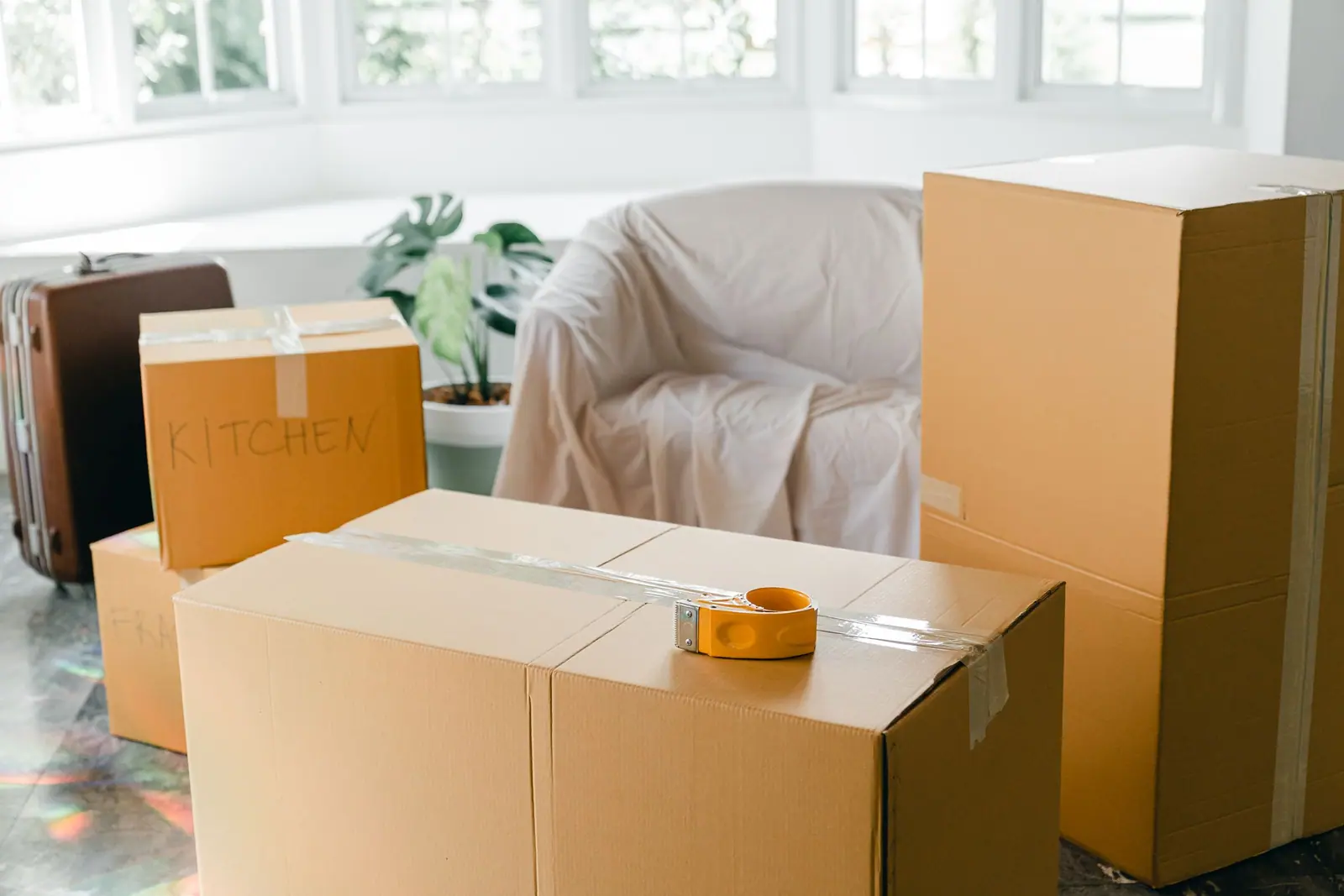 Taped boxes and a covered armchair